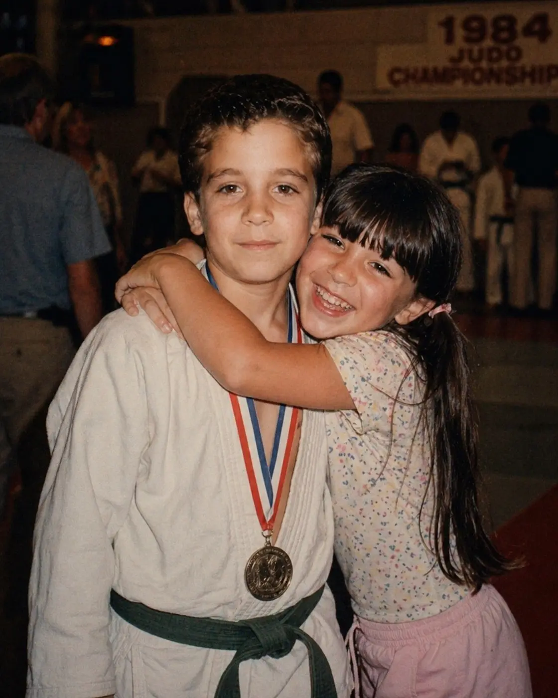 A young Billy Gavigan wearing a judo gi and medal at a 1984 club championship