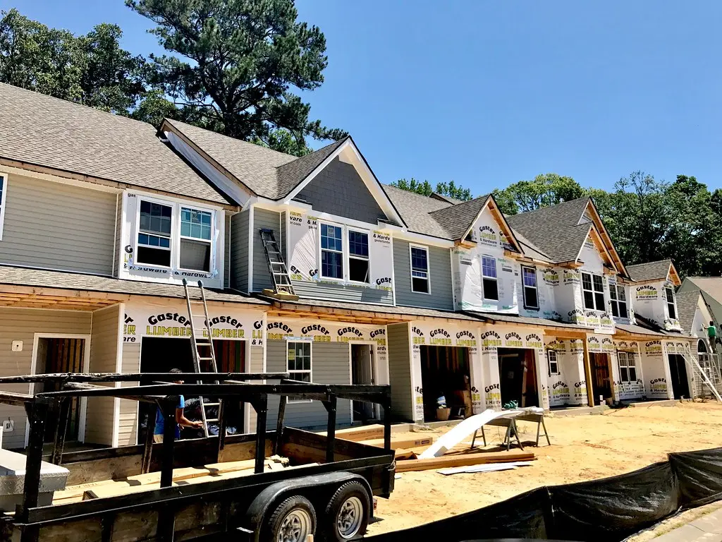 Multiple attached townhomes under active construction at Azalea Square