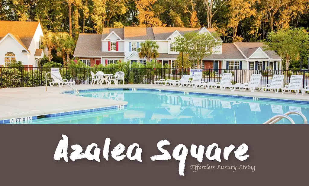 Azalea Square community pool framed by completed townhomes and clubhouse landscaping